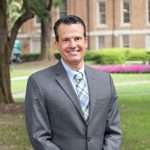 Frank Rizzo, Vice President of Student Life, stands on Main Lawn at William Peace University.
