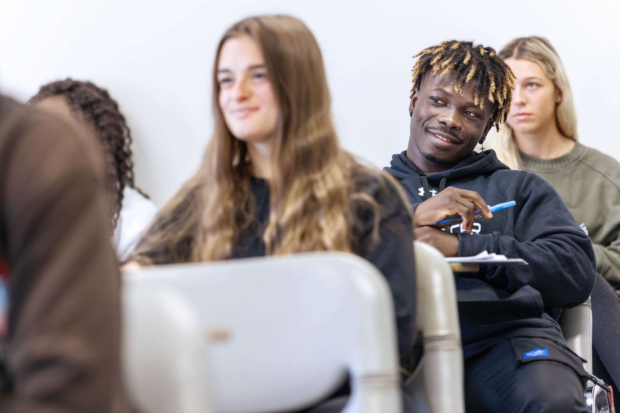 Students listen and answer questions during class.